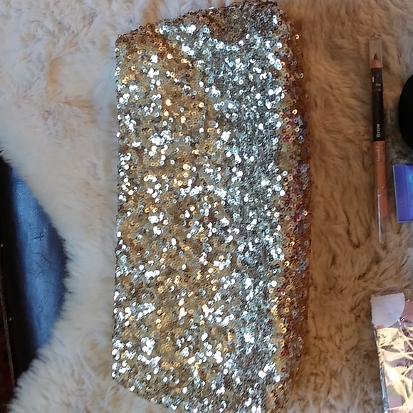 Gold Victoria's secret bag filled with a variety of beauty products. - Picture 4 of 13